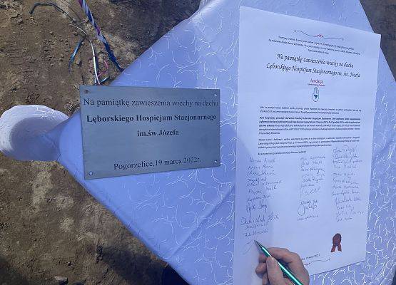 Podpisy uczestników wydarzenia pod pamiątką zawieszenia wiechy.